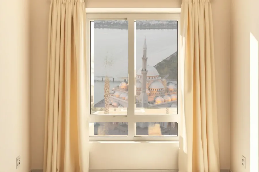 Illustrative view: a room with made-to-measure curtains and Al Noor Mosque on Khalid Lagoon beyond the window