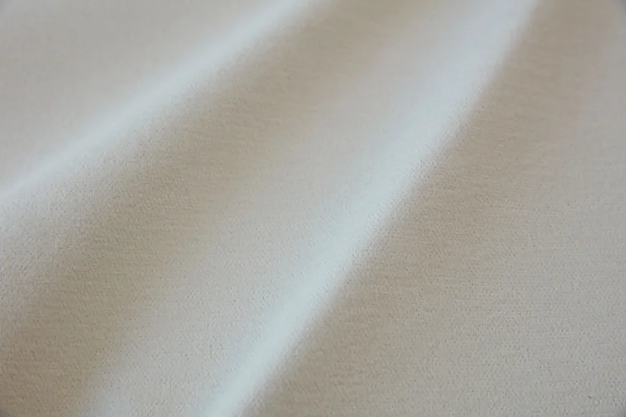 Catalogue 302 shade 302-03, Natural Ivory Cream — blackout curtain fabric close-up showing the weave and drape