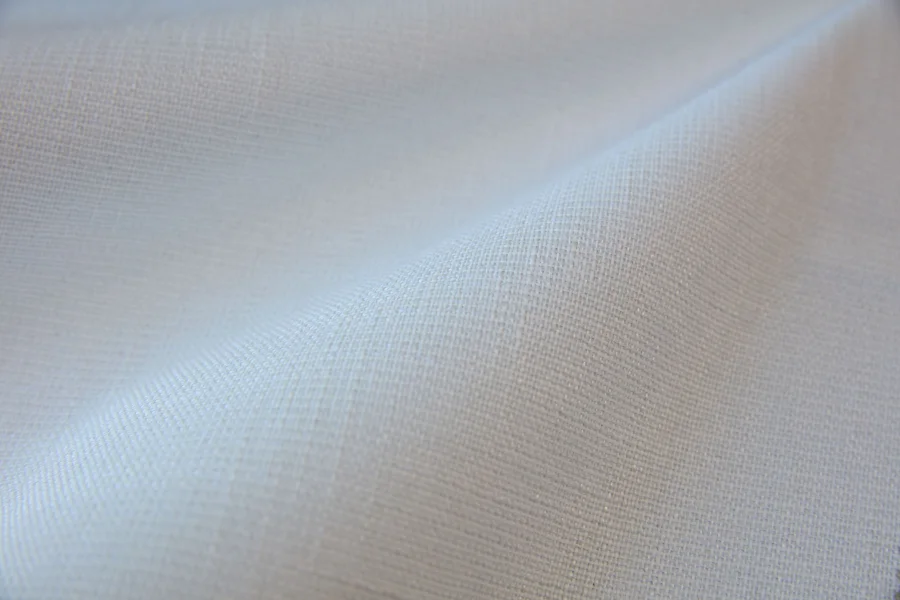 Catalogue 303 shade 303-01, Ivory — blackout curtain fabric close-up showing the weave and drape