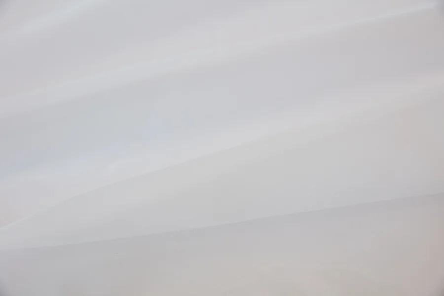 Catalogue 401 shade 401-01, White More White Plain — chiffon sheer curtain fabric close-up showing the weave and drape