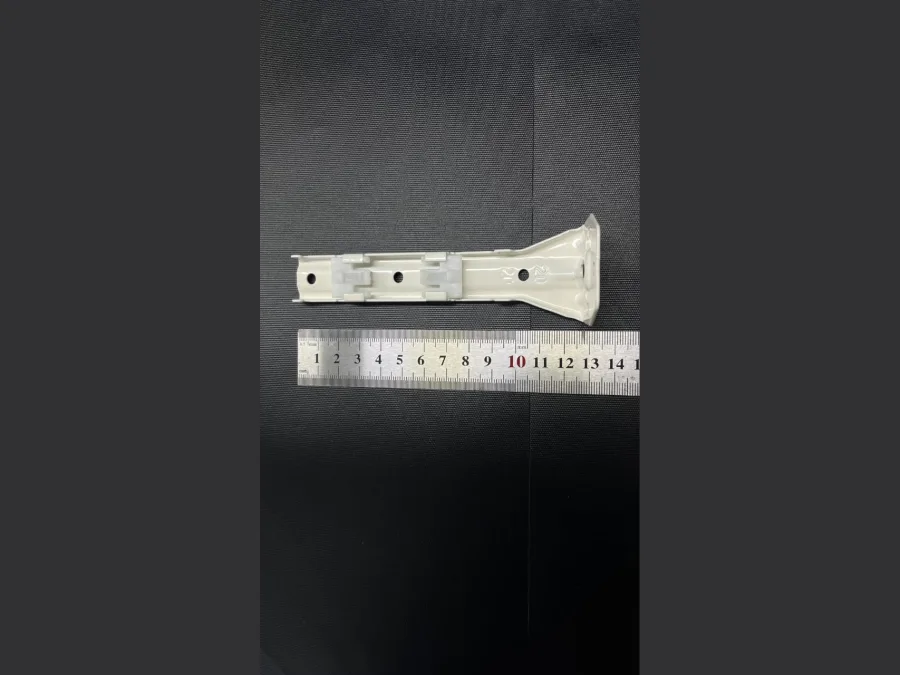 Long double curtain track wall bracket shown against a ruler