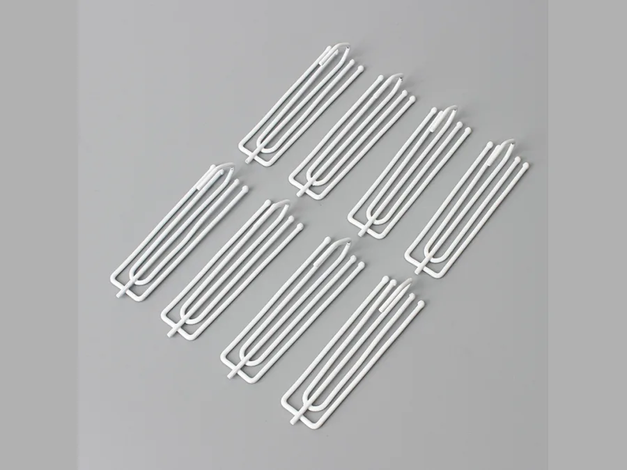 Several metal pinch pleat curtain hooks