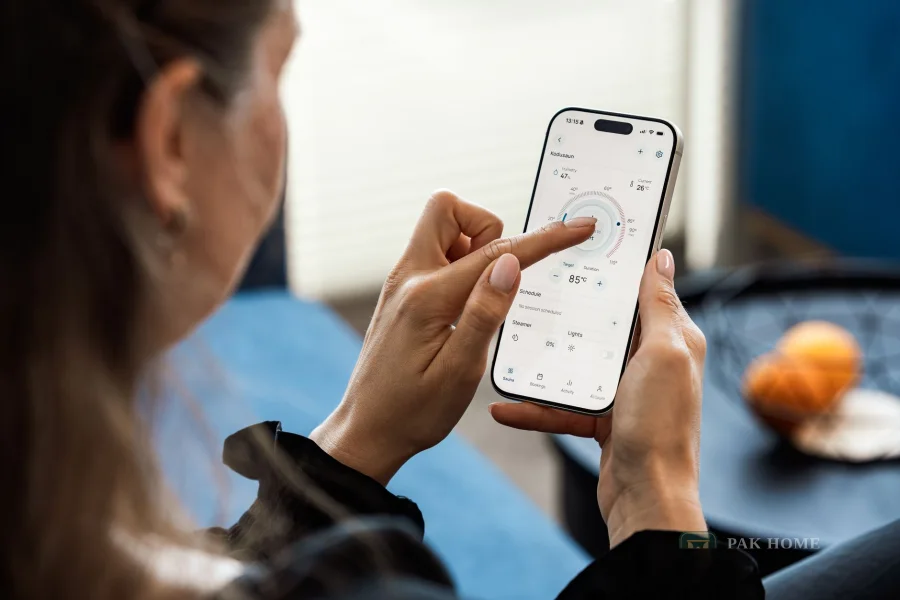 Woman using a phone app indoors to control a connected system