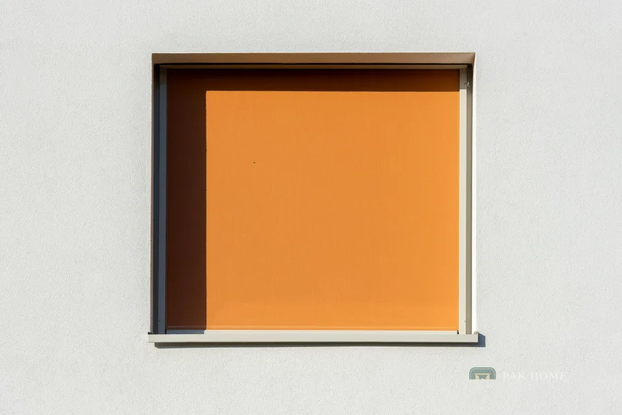Roller blind pulled down over a window set in a plain white wall