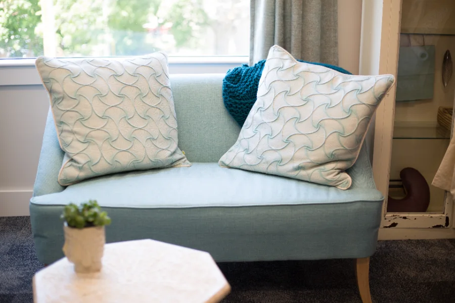 Living room seating beside a curtained window